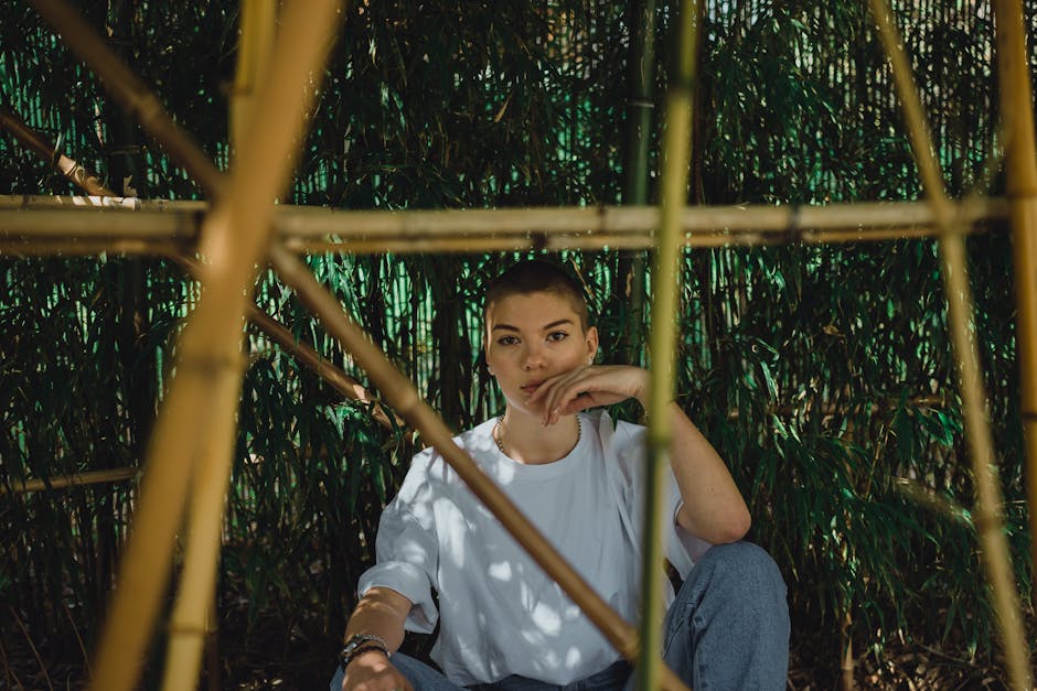 A peaceful person sitting in a meditative pose with natural light filtering in.